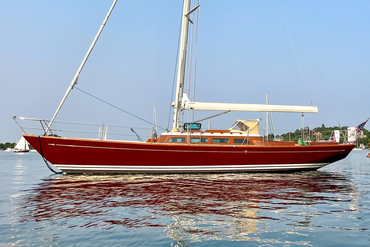 Red Morris M42 sailboat from 2011 on calm water