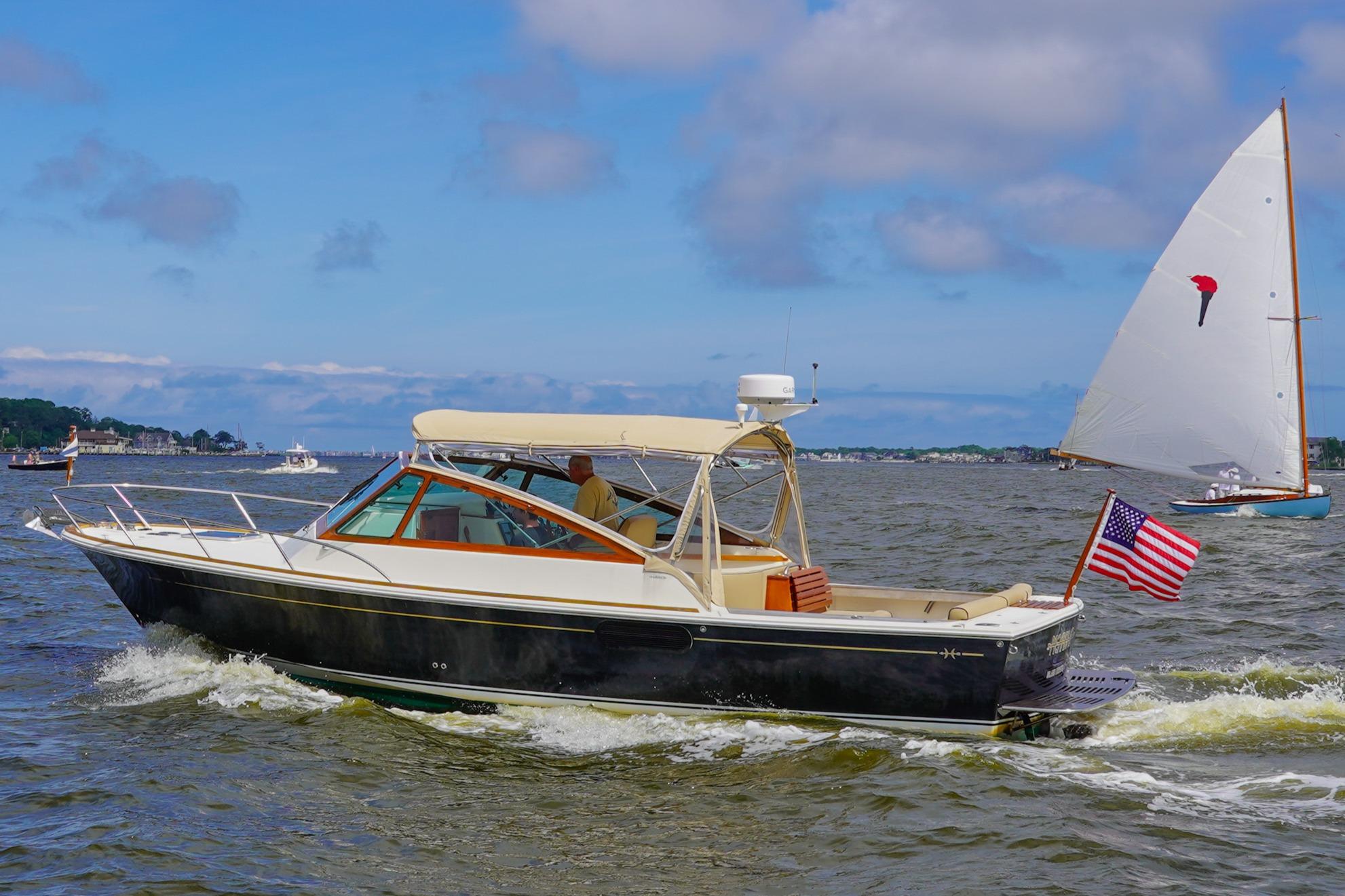 2009 Hunt Yachts Harrier 29 cruising on a sunny day with American flag.