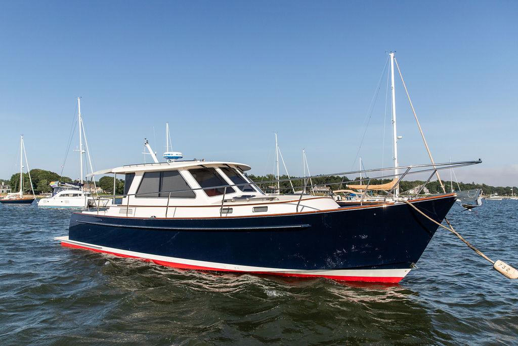 2014 Bruckmann Abaco 40 yacht anchored in a scenic harbor.